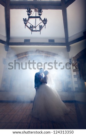 mysterious wedding kiss the bride and groom in the room of a medieval style