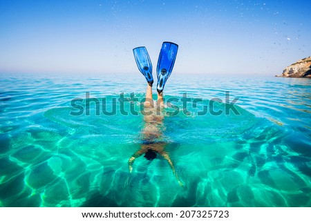 Women snorkeling in clear water on the beach Islands. Girl dives under the sea.
