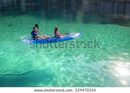 Kayaking. Young happy couple traveling by kayak. Activities on the water. Sailing on the sea.