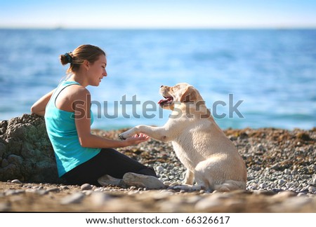 Young woman with her dog at the beach