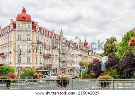KARLOVY VARY, CZECH REPBULIC - SEPTEMBER 15, 2012: Cars move round traffic circle in historical spa town famous for elaborate, pastel architecture, thermal baths, and health treatment facilities.