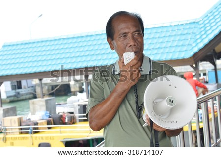 TARAKAN, INDONESIA - SEPTEMBER, 20, 2015 : a ticket vendor announced speed ready to go with loudspeakers on Sept 20, 2015  in Tarakan, Indonesia