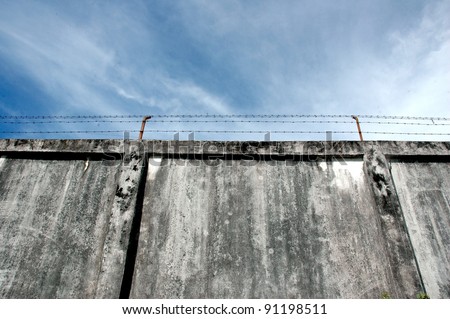 the prison walls with high walls and barbed iron wire
