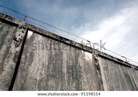 the prison walls with high walls and barbed iron wire