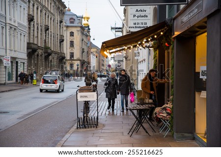 COPENHAGEN, DENMARK - 30 DECEMBER, 2014: The central streets of Copenhagen with many cozy restaurants and cafes. December 30, 2014 Copenhagen, Denmark.