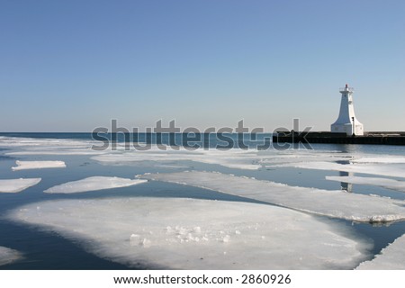 sheets of ice melt in harbour by pier
