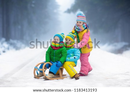 little girl and boy enjoying sleigh ride child sledding toddler kid riding a sledge - Christmas Vacation Sled little girl and boy enjoying sleigh ride child sledding toddler kid riding a sledge - Christmas Vacation Sled
