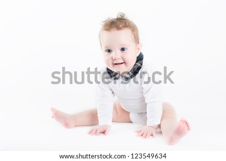 Funny baby girl sitting with a white background