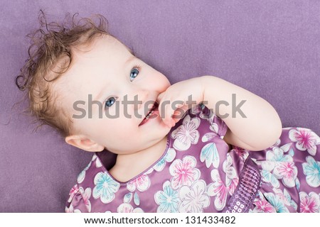 Beautiful little girl in a purple dress