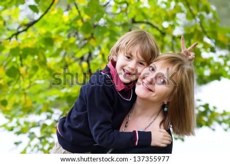 Grandmother and grandson on a walk in a park