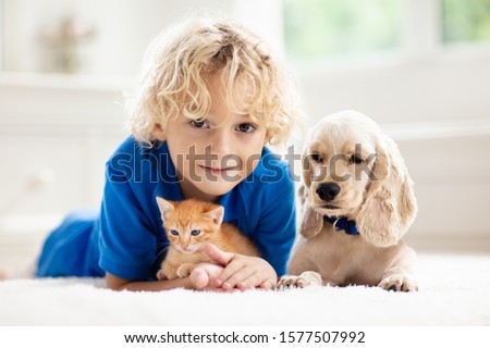 Similar – Image, Stock Photo Little boy and cat taking selfie with mobile phone on bed