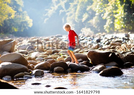 Similar – Image, Stock Photo Child playing with rocks and sand