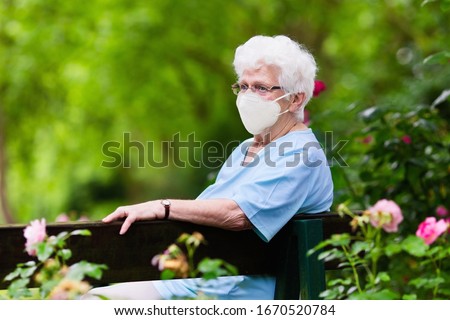 Senior woman wearing face mask during corona virus and flu outbreak. Disease and illness protection. Surgical masks for coronavirus prevention. Sick elderly patient coughing. Ill person.