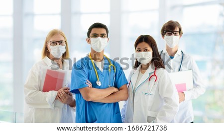 International doctor team. Hospital medical staff. Mixed race Asian and Caucasian doctor and nurse meeting. Clinic personnel wearing face mask and stethoscope. Coronavirus outbreak. 商業照片 © 