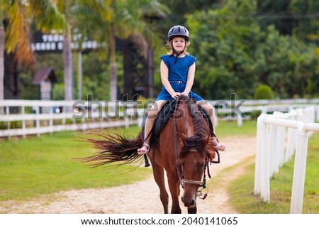 Similar – Foto Bild Kleines Mädchen reitet Pferd auf dem Hippodrom