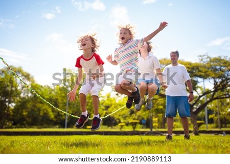 Similar – Image, Stock Photo Cute girl playing in the fields with dog