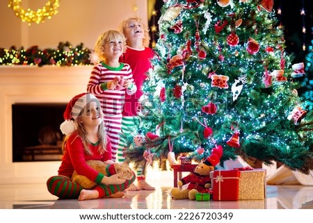 Similar – Image, Stock Photo Boy decorating Christmas tree in evening