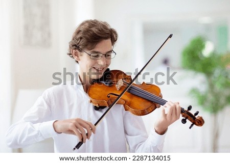 Similar – Image, Stock Photo Violin and bow in the hand of the musician in an empty room. Ban on performing in the Corona Crisis