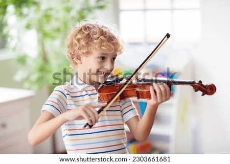 Similar – Image, Stock Photo Violin and bow in the hand of the musician in an empty room. Ban on performing in the Corona Crisis