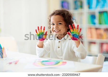 Similar – Image, Stock Photo Little girl preschooler painting a picture using colorful paints and crayons. Child having fun making a picture during an art class in the classroom