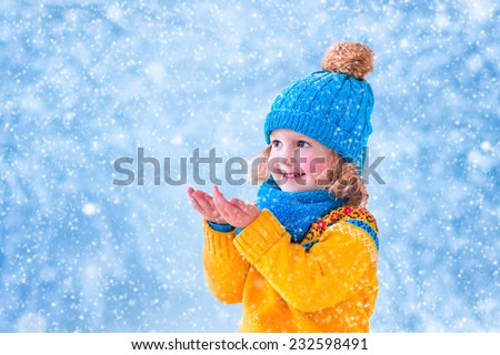 Similar – Image, Stock Photo A little girl catches soap bubbles in the park, sitting on the grass. The concept of a happy childhood