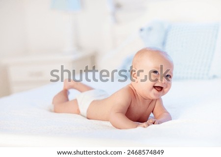 Similar – Image, Stock Photo A laughing baby in a bright swimsuit learns to swim in the pool in the garden with the help of an inflatable circle. Summer time, recreation, rear view