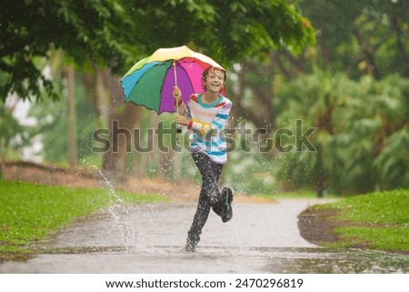 Similar – Foto Bild Kind mit grünem Regenschirm