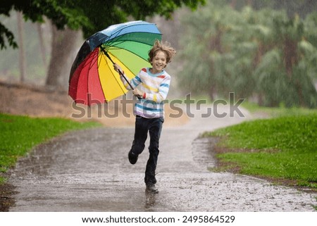 Similar – Foto Bild Kind mit grünem Regenschirm