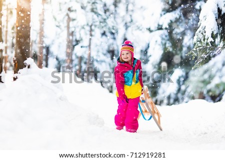 little girl enjoying a sleigh ride child sledding toddler kid riding a sledge - Christmas Vacation Sled little girl enjoying a sleigh ride child sledding toddler kid riding a sledge - Christmas Vacation Sled