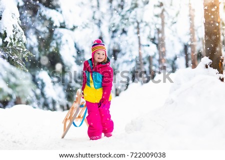 little girl enjoying a sleigh ride child sledding toddler kid riding a sledge - Christmas Vacation Sled little girl enjoying a sleigh ride child sledding toddler kid riding a sledge - Christmas Vacation Sled