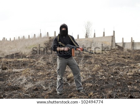 Warrior with gun in the battlefield