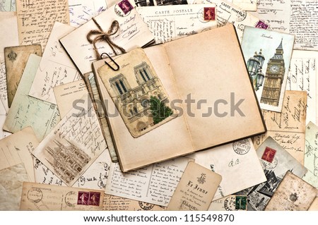 old postcards and open empty book. vintage travel background