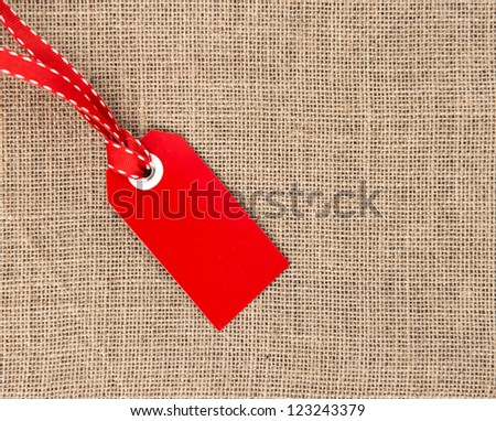 red label with ribbon on burlap background