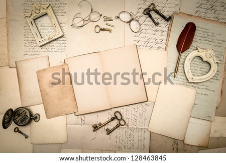 open book, vintage accessories, old letters, pages, photo frames, glasses, keys, clock. nostalgic background