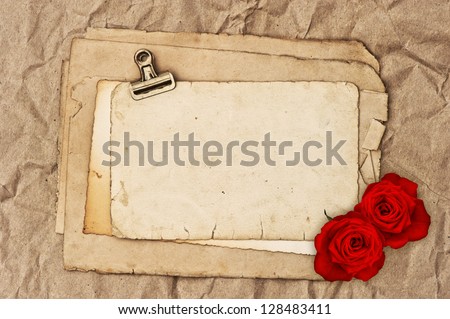 old blank paper and two rose flowers. grunge vintage background