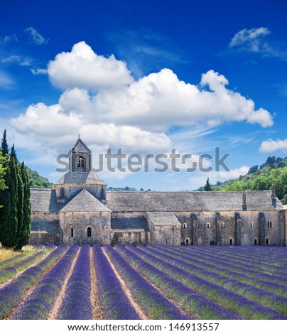 Senanque abbey with lavender field, landmark of Provence, Vaucluse, France. Beautiful landscape with medieval castle and cloudy blue sky