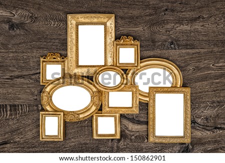 antique golden frame over rustic wooden background. empty baroque frame for photo and picture