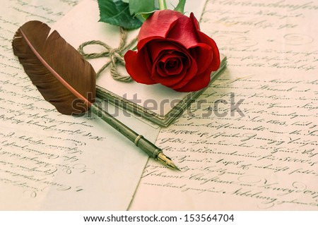 old love letters, rose flower and antique feather ink pen. romantic vintage background. selective focus