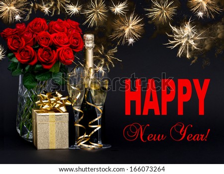 Happy New Year! card concept. red roses, bottle of champagne, golden gift with beautiful golden fireworks on black background