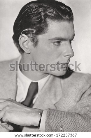 GERMANY, BERLIN - CIRCA 1935: retro style portrait of handsome young man in suit. vintage photograph with original film grain. art deco. Illustrative Image, subject of human interest