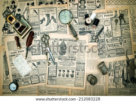 antique accessories, sewing and writing tools, vintage fashion newspaper for the woman with advertising. retro style toned picture