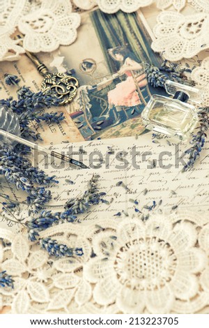 vintage ink pen, key, perfume, lavender flowers and old love letters. retro style toned picture