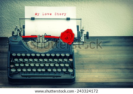 Vintage typewriter with white paper and red rose flower. Sample text My Love Story. Vintage style toned grungy picture