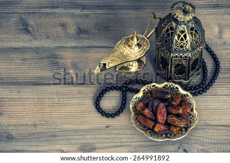 Dates, arabian lantern and rosary. Islamic holidays concept. Ramadan decoration. Retro style toned picture