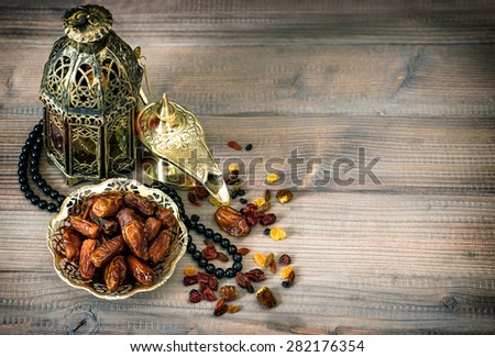 Dates, arabic lamps and rosary. Islamic holidays decoration concept. Vintage style toned picture