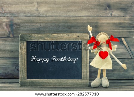 Cute doll with Red Heart. Lovely Birthday decoration. Holidays card concept. Vintage style toned picture