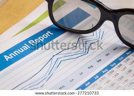 Annual Report letter document and eyeglass