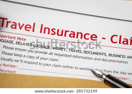 Travel Insurance Claim application form and pen on brown envelope, business insurance and risk concept; document is mock-up