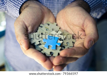 diversity of puzzle piece on handful