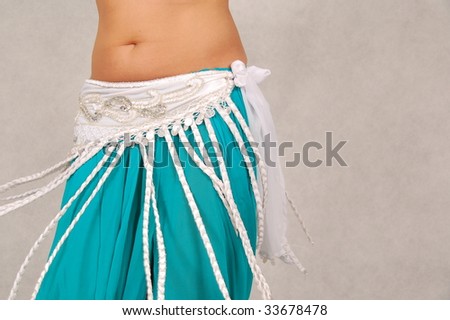 belly-dancer in traditional white and turquoise costume